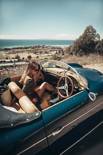 automobile woman sitting on car car