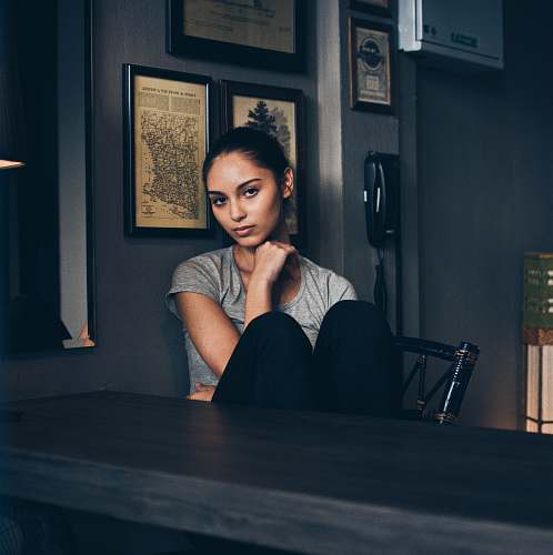 human woman sitting on chair infront of empty table person