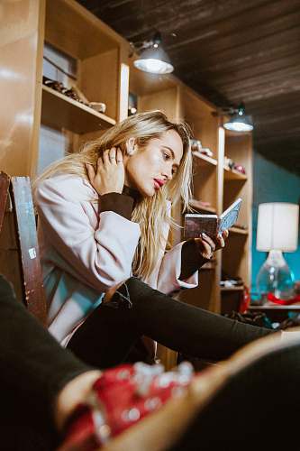 human woman sitting on chair looking at mirror person