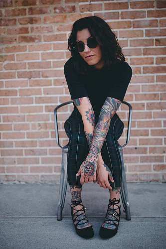person woman sitting on chair tattoo