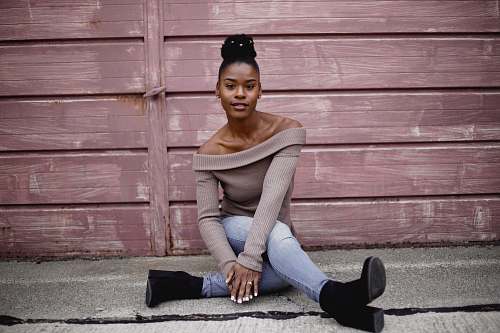human woman sitting on concrete floor person