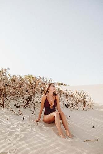 human woman sitting on sand person