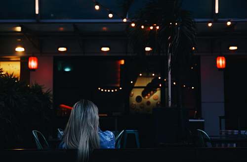 person woman sitting while facing towards bar singapore