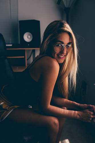 human woman sitting while smiling person