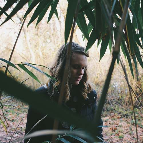 person woman standing in forest woman