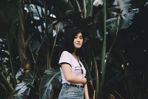 person woman standing in front of banana tree at daytime woman