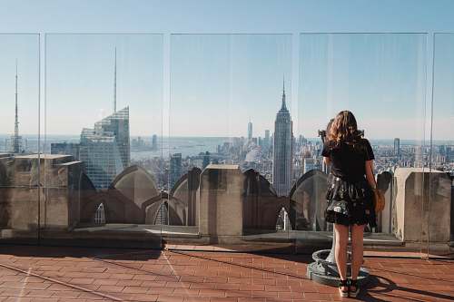 human woman standing near glass wall person