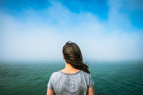 human woman standing near the body of water person