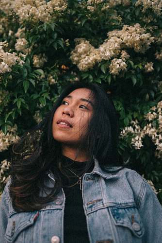 person woman standing near white petaled flowers human