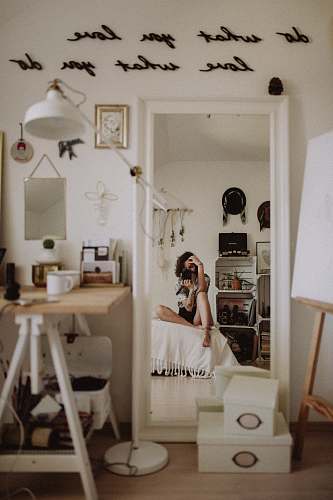 person woman taking selfie while sitting on white pad human
