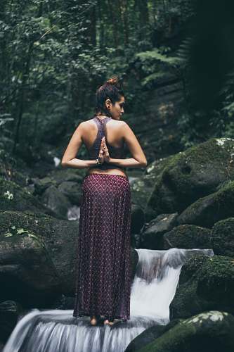 human woman twisting her arms to her back person