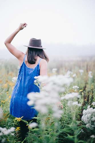 girl woman walking a flower field woman
