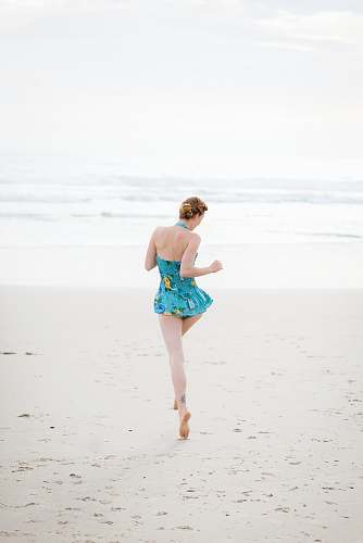 human woman walking on shore near beach beach