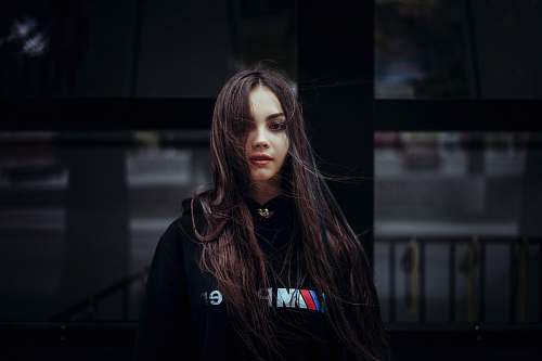 human woman wearing black pullover hoodie person