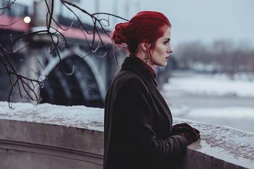 human woman wearing black suit standing near the building person
