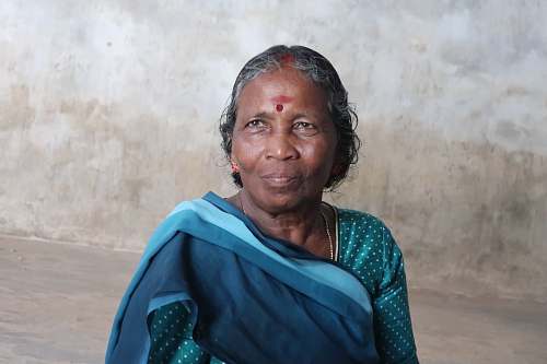 human woman wearing blue and teal polka-dot sari dress person