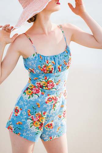 person woman wearing blue floral rompers and brown hat human