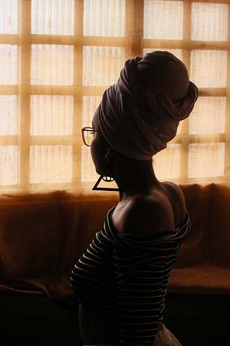 human woman wearing eyeglasses facing window person