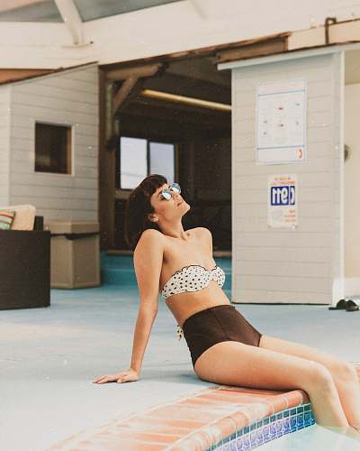 person woman wearing white and black polka-dot bikini human