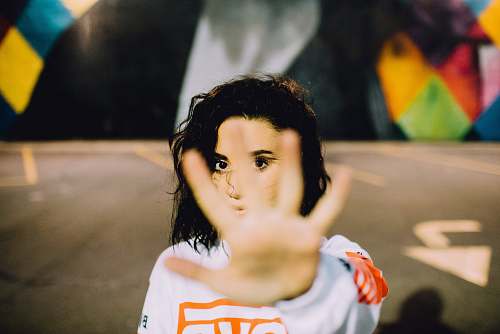 human woman wearing white and orange top person