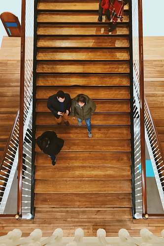 people aerial photography of person walking on stair human