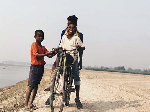 people boy riding on bike human