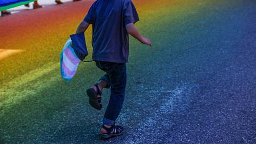 human boy running through road people