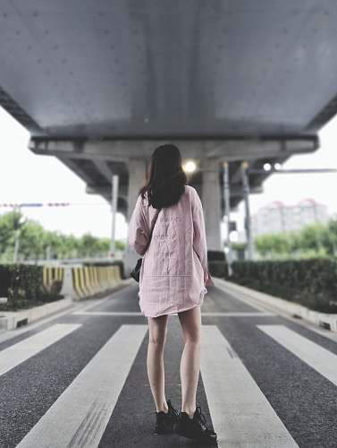 people girl standing on pedestrian lane during daytime human