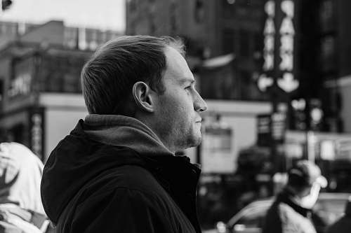people greyscale photography of man looking far away black-and-white