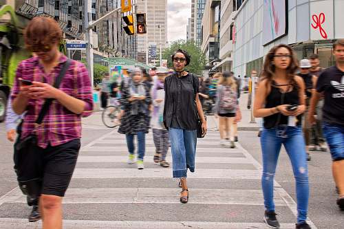 human group of people passing through pedestrian lane during daytime people