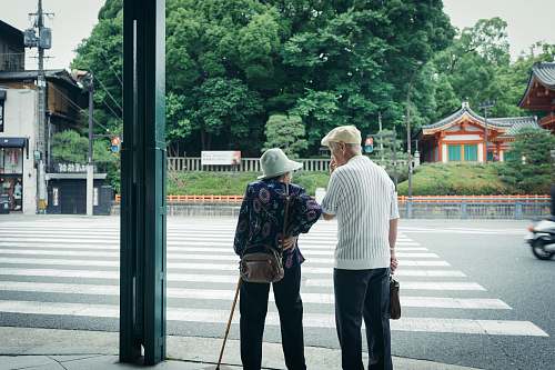 human man and woman standing in front of pedestrian line people