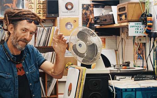people man beside white desk fan human