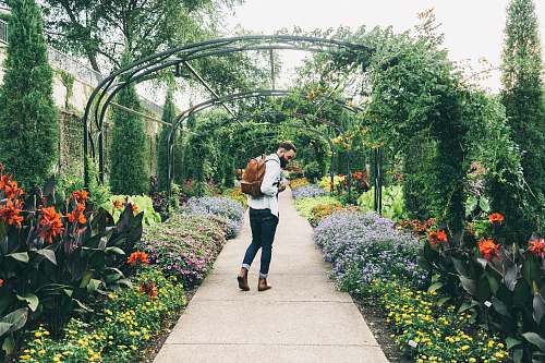 people man carrying backpack walking on garden nashville