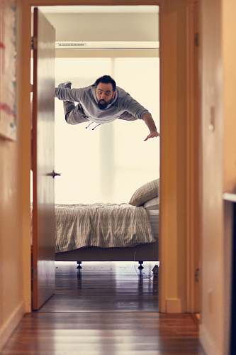people man falling from ceiling on bed human