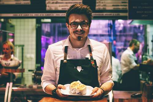 people man holding fish dish on plate human