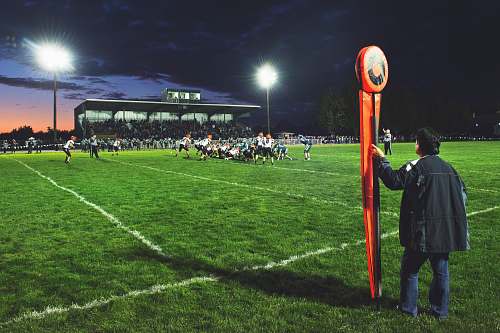 people man holding football field post on side of field human