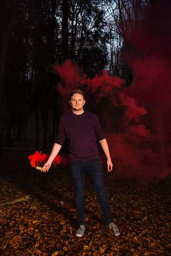 human man holding red smoke people