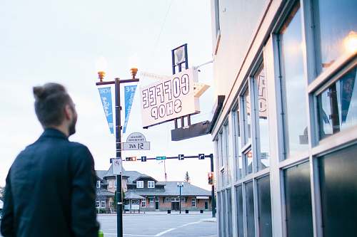 building man in front of coffee shop store human