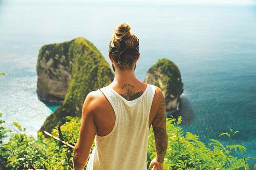 people man in white tank top facing near the cliff human
