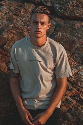 people man leaning on rock while posing human