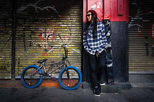 people man leaning on wall bike