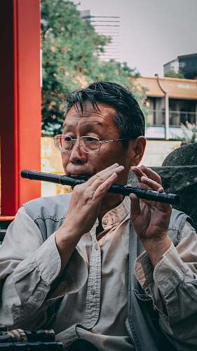 people man playing black flute human