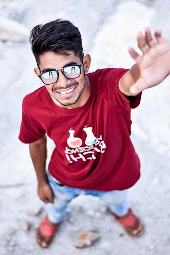 human man raising left hand while standing people