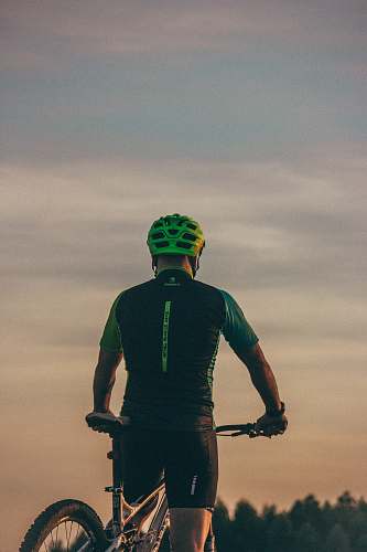 human man riding bicycle during day time bike