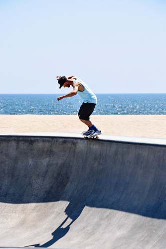 human man riding skateboard doing trick people
