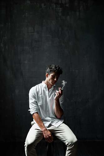 people man sitting on chair smoking cigar human