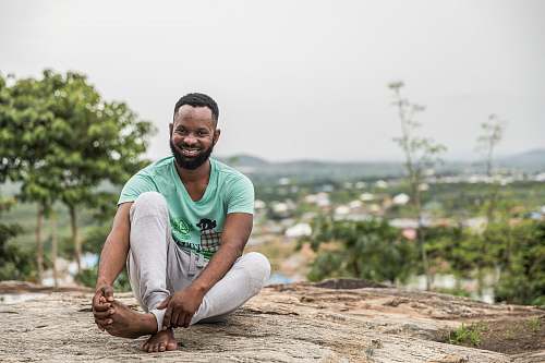 human man sitting on rock people