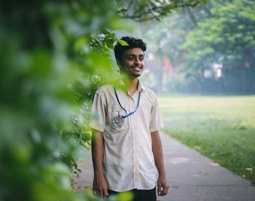 human man standing beside tree people
