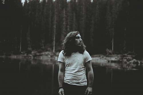 people man standing near body of water grey