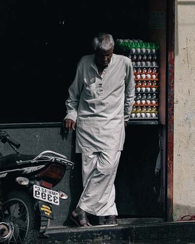 human man standing near motorcycle motorcycle
